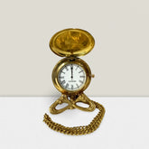 Gold pocket watch for men with chain on white background